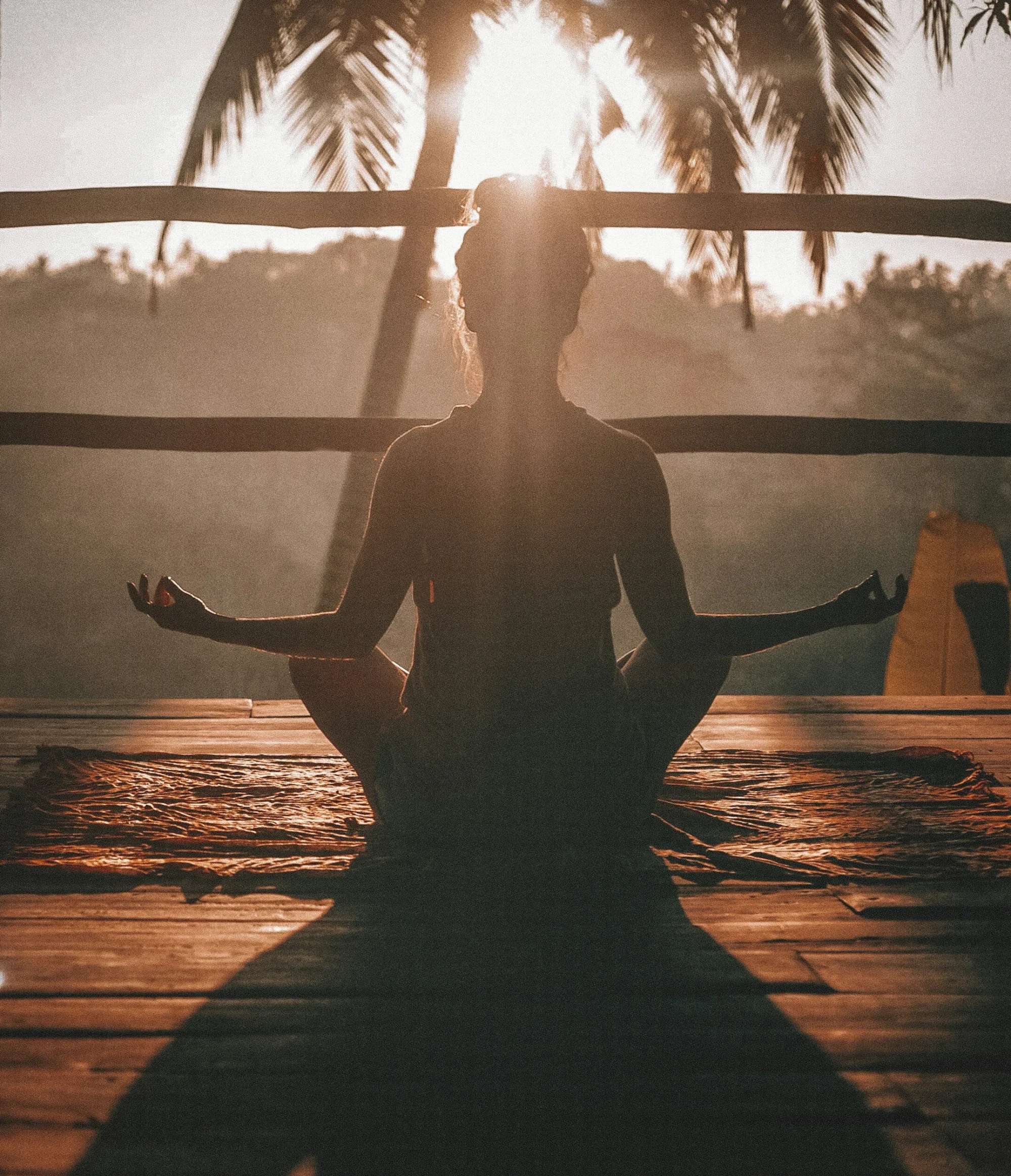 Silhouette of a person meditating at sunrise